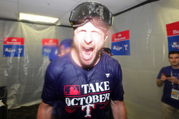Oct 4, 2023; St. Petersburg, Florida, USA; Texas Rangers starting pitcher Max Scherzer (L) celebrates in the locker room after defeating the Tampa Bay Rays in game two of the Wildcard series for the 2023 MLB playoffs at Tropicana Field. Mandatory Credit: Nathan Ray Seebeck-USA TODAY Sports